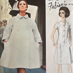 May include: Vintage Vogue Couturier Design sewing pattern. The pattern features a woman in a light gray coat and a drawing of a white dress. The text reads "1577 by Fabiani of Italy."