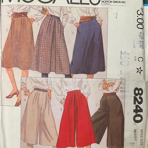 May include: McCall's sewing pattern number 8240 for a women's skirt. The pattern includes four different skirt styles: a brown skirt, a plaid skirt, a blue skirt, and a pair of culottes. The pattern is for sizes 14 and 28 waist.