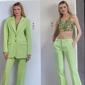May include: Vogue Patterns sewing pattern featuring a lime green suit and a leopard print crop top and trousers. The pattern includes a blazer, trousers, and a crop top. The pattern number is V1960.