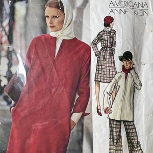 May include: A vintage Vogue Americana Anne Klein sewing pattern envelope 1158. The front features a photograph of a red long-sleeved dress and illustrations of a plaid dress and a white tunic with plaid trousers, all with a clean, structured design.