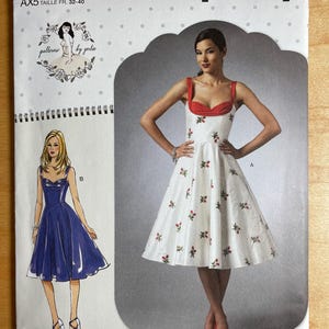 May include: Simplicity sewing pattern S9284 featuring a woman in a white dress with red accents and floral details. The pattern includes dress designs and sizing information for US sizes 4-12.