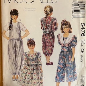 May include: A sewing pattern for a girl's jumpsuit with three different styles. The pattern includes a striped jumpsuit, a floral print jumpsuit, and a floral print dress. The pattern is for sizes 7, 8, and 10. The pattern is from McCall's and the pattern number is 5476.