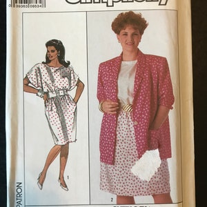 May include: Simplicity sewing pattern number 9048 for size 22W. The pattern includes instructions for making a dress and a jacket. The dress is white with red polka dots and has a short sleeve. The jacket is pink with a white and pink floral pattern. The pattern is labeled "BBW" for "Big Beautiful Woman".