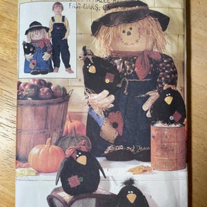 May include: A sewing pattern for a scarecrow doll and crow decorations. The scarecrow doll wears a hat, overalls, and a plaid shirt. The crows are black with patches and bows. The pattern is labeled "Butterick" and "Luv 'N Stuff".