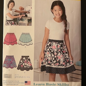 May include: Simplicity Learn to Sew pattern featuring a girl wearing a floral skirt. The pattern includes illustrations of different skirt designs and instructions for basic sewing skills. Size U.S. 8-16.