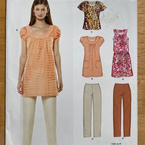 May include: A New Look sewing pattern featuring a woman modeling a peach-colored tunic and cream-colored pants. The pattern also shows illustrations of various tops, a dress, and pants. The text "NEW LOOK" is at the top.