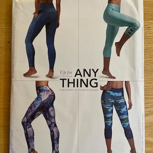 May include: Simplicity pattern 8561 features leggings in various styles. The pattern includes high-rise and mid-rise options with stirrups, side panels, pockets, and contrast panels. The leggings come in sizes 1XL-5XL. The text "Up for ANYTHING" is visible.
