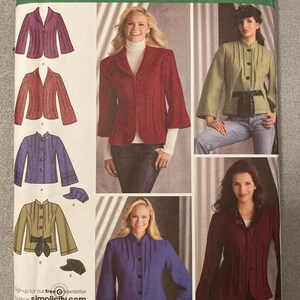 May include: Simplicity sewing pattern 3563 featuring various jacket designs. The pattern includes images of jackets in shades of red, purple, and green. The pattern is labeled "easy-to-sew" and includes sizing information.