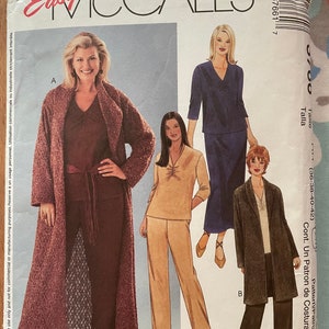 May include: A sewing pattern for women's clothing. The pattern includes three different styles: a long cardigan, a pantsuit, and a long coat. The pattern is from McCall's Easy Womanstyle and has the number 23795 37661 7.