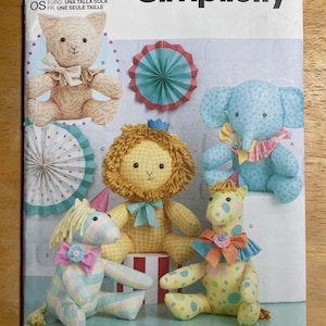 May include: Simplicity sewing pattern S9498 featuring stuffed animal designs. The pattern includes instructions for a bear, elephant, lion, giraffe, and unicorn. The pattern is designed and printed in the USA.