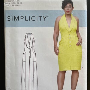 May include: A Simplicity sewing pattern envelope featuring a yellow dress with a halter neckline and button details. The envelope includes a line drawing of the dress and the text "SIMPLICITY" and "Mimi G Style". Sizes are listed in U.S., Euro, and French measurements.