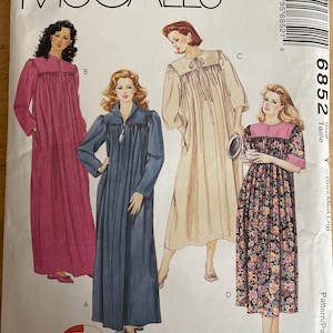 May include: A sewing pattern for a 3-hour robe. The pattern includes four different styles: a pink robe, a blue robe, a cream robe, and a floral robe. The pattern is from McCall's and the pattern number is 6852.