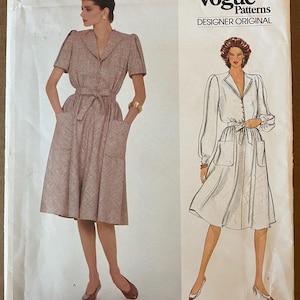 May include: A vintage Vogue Designer Original sewing pattern for a dress by Valentino. The pattern is for a dress with a collar, long sleeves, and a belt. The pattern number is 2941.