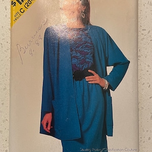 May include: A sewing pattern for a blue skirt and jacket set. The pattern is labeled "See & Sew by Butterick 6518" and is marked "Very Easy/Très Facile".