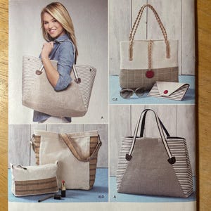 May include: Simplicity sewing pattern S9398 featuring tote bags and a clutch. The bags have striped and solid fabric panels, with various handle styles. The pattern includes instructions for different sizes and designs.