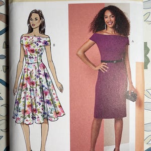 May include: Butterick sewing pattern B7006. The pattern shows illustrations of two off-the-shoulder dresses. One is a floral print, and the other is a solid purple colour. The pattern includes size Y5 (18-20-22-24-26).