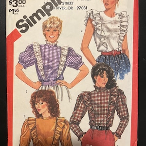 May include: Vintage Simplicity sewing pattern, size 8, showcasing four blouse designs with ruffled details. The illustrations depict blouses in various colors and patterns, including gingham and plaid. The pattern includes a special chart for working with plaids.