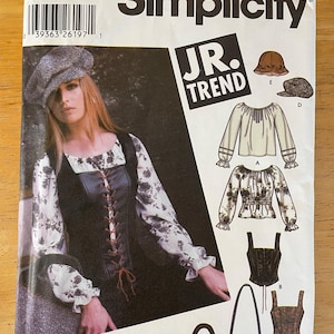 May include: Simplicity sewing pattern number 5799, size AA, for a junior trend top, vest, and bag. The pattern includes instructions for making a peasant style top, a lace-up vest, and a small bag with a flap.