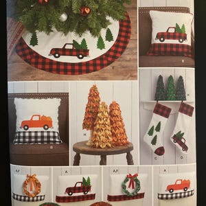 May include: Simplicity pattern featuring Christmas-themed designs. Includes a tree skirt, pillows with truck and tree appliqués, decorative trees, and stockings. The designs incorporate red and black buffalo check patterns and festive elements.