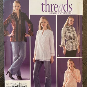 May include: Simplicity Threads Magazine Collection sewing pattern number 4017. The pattern includes instructions for three different tops: a brown velvet top with a V-neck, a white eyelet top with a V-neck, and a pink button-down top. The pattern is for sizes H5 6, 8, 10, 12, 14, EUR. 32-40, FR. 34-42.