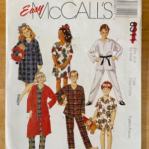May include: A sewing pattern for children's pajamas. The pattern includes five different styles: a plaid robe, a plaid pajama set, a plaid nightgown, a solid white robe, and a floral pajama set. The pattern is for sizes 2 and 4. The pattern is from McCall's Easy.
