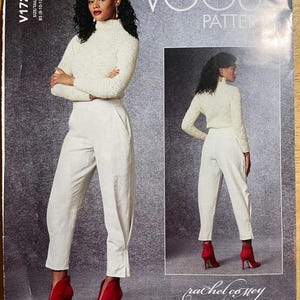 May include: Vogue Pattern V1729 features a woman in a cream-colored turtleneck sweater and white pants, paired with red high-heeled boots. The pattern includes a smaller image of the outfit. The Vogue logo is visible.