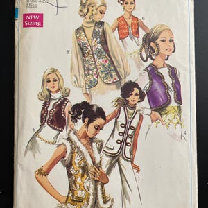 May include: Vintage Simplicity sewing pattern, featuring illustrations of women's vests and outfits. The pattern includes the number 8143, size 10, and bust 82.5 cm. The cover has a retro design with the text "NEW Sizing".
