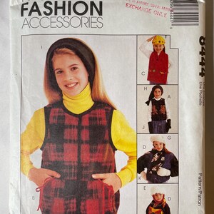 May include: A McCall's Fashion Accessories sewing pattern envelope, number 8444, featuring illustrations of various garments including a red and black plaid vest, a dark vest with bear motifs, a blue jacket, and a scarf, with text and a barcode.