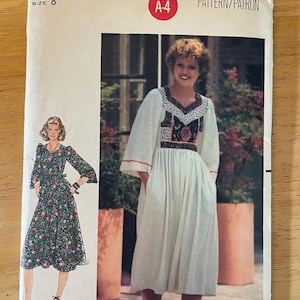 May include: A vintage sewing pattern for a dress with a white bodice and a floral print skirt. The pattern is from Butterick and is size 8. The pattern number is 5948 and the price is £1.75.