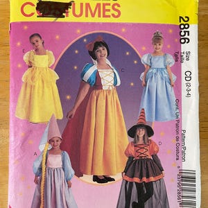 May include: A McCall's costume pattern with images of children in princess and witch outfits. The pattern includes a yellow dress, a Snow White-style dress, a blue dress, and a witch costume. The pattern size is CD (2-3-4).