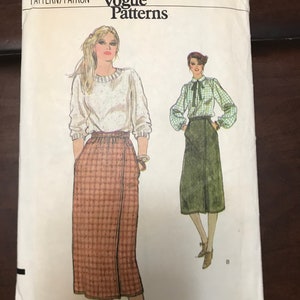 May include: A vintage sewing pattern for a skirt and blouse. The pattern is for size 10 and is from Very Easy Vogue Patterns. The pattern shows two different styles of the skirt, one with a plaid pattern and the other with a solid green color.