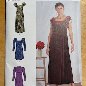 May include: Simplicity sewing pattern S9453 featuring three dress designs. The pattern includes a long floral dress, a blue dress with long sleeves, and a purple dress with long sleeves. The pattern is designed and printed in the USA.