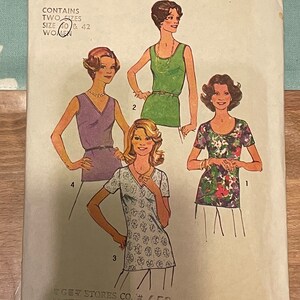 May include: A sewing pattern for two tops, sizes 40 and 42. The pattern shows four different women wearing the tops. The tops are all sleeveless and have a V-neck. The pattern is from Simplicity and is number 7911.