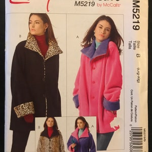 May include: A sewing pattern titled "Easy stitch'n save" by McCall's, model M5219. The pattern features a coat with a reversible collar and cuffs. The main image shows a black coat with a leopard print collar and cuffs, and a pink coat with a blue collar and cuffs.