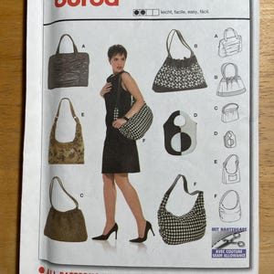 May include: A Burda sewing pattern featuring various handbag designs. The pattern includes images of handbags in different styles, including tote bags, shoulder bags, and drawstring bags. The pattern's text includes the words "leicht, facile, easy, fácil."