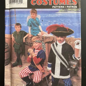 May include: Simplicity Costumes pattern for children's costumes. The pattern features various pirate and fairytale-themed outfits, including a pirate, Peter Pan, and other characters. The package is labeled size A (SM-LG).
