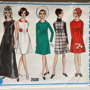 May include: A vintage sewing pattern featuring five different dress designs. The dresses are in various colors, including black, white, green, red, and plaid. The pattern number is 2036. The text "Vogue's Basic Design" is printed on the right side of the pattern.