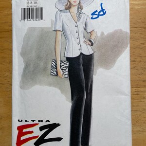 May include: A vintage Vogue Ultra EZ sewing pattern, featuring a fashion illustration of a woman in a white short-sleeved jacket, black pants, and a wide-brimmed hat. The pattern number is 9439, with sizes 6-8-10. The price is $9.50.