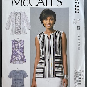 May include: A McCall's sewing pattern envelope with illustrations of women's tops. The main image shows a woman wearing a striped top. The envelope includes the pattern number M7390 and size E5.