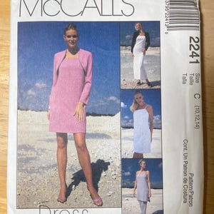 May include: McCall's dress pattern featuring a pink dress with a matching jacket. The pattern includes multiple dress styles, with images of the finished garments. The package is white with the text "McCall's" at the top.
