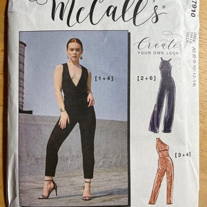 May include: McCall's sewing pattern featuring a black jumpsuit with a plunging neckline. The pattern includes multiple view options and the text "Create Your Own Look". The size is A5 (6-8-10-12-14).