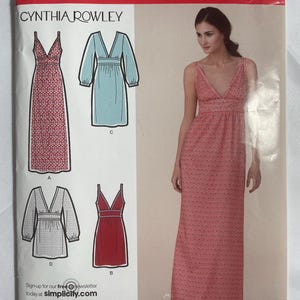 May include: Simplicity sewing pattern featuring Cynthia Rowley designs. The pattern includes options for various dresses, with a model wearing a red patterned maxi dress. The package has the number 2587 and size information.