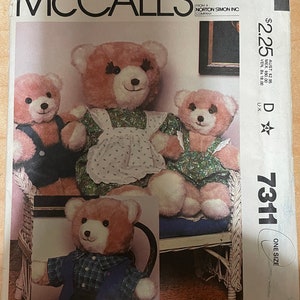 May include: A sewing pattern for making a teddy bear. The pattern is from McCall's and is for one size. The pattern includes instructions for making a teddy bear with a dress, a teddy bear with a shirt, and a teddy bear with overalls.