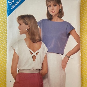 May include: A vintage sewing pattern for a women's top with two different styles. The pattern is for sizes 6-8-10 and is called "See & Sew" 5385.