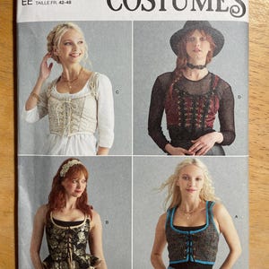May include: Simplicity Costumes sewing pattern S9592. The pattern features four costume designs, including tops with lace-up details. The pattern is designed and printed in the USA. Size U.S. 14-20.