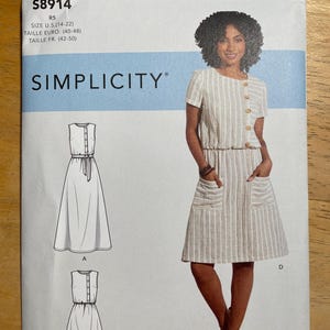 May include: Simplicity sewing pattern S8914 featuring a striped dress design. The pattern includes sizes U.S. 14-22, Euro 40-48, and French 42-50. The image shows a woman wearing a similar dress. The pattern includes multiple dress styles.