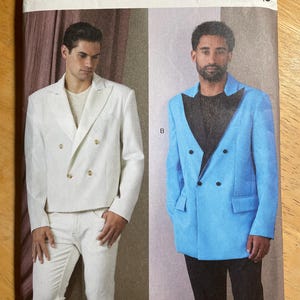 May include: Vogue Patterns sewing pattern featuring two double-breasted suit jacket designs. One jacket is white, the other is light blue. The pattern includes sizes MUU (34-36-38-40). Designed and printed in the USA.