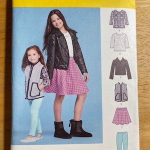 May include: Simplicity sewing pattern 8027 for girls' clothing. The pattern includes options for a jacket, vest, skirt, and trousers. The cover features two girls modeling the clothing. The size range is 7-14.