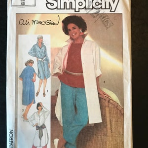 May include: Simplicity sewing pattern number 6846 for a long shirt with a sash and pants. The pattern is signed by Ali MacGraw. The pattern is for sizes 12-40.
