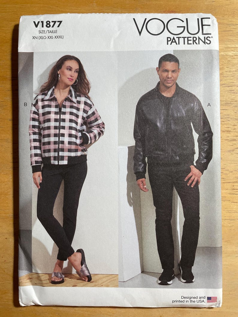 May include: Vogue Patterns sewing pattern V1877. The pattern features two jacket designs. One jacket is a black and white plaid with a zipper closure. The other jacket is a black leather bomber jacket. The pattern size is XN (XLG-XXL-XXXL).